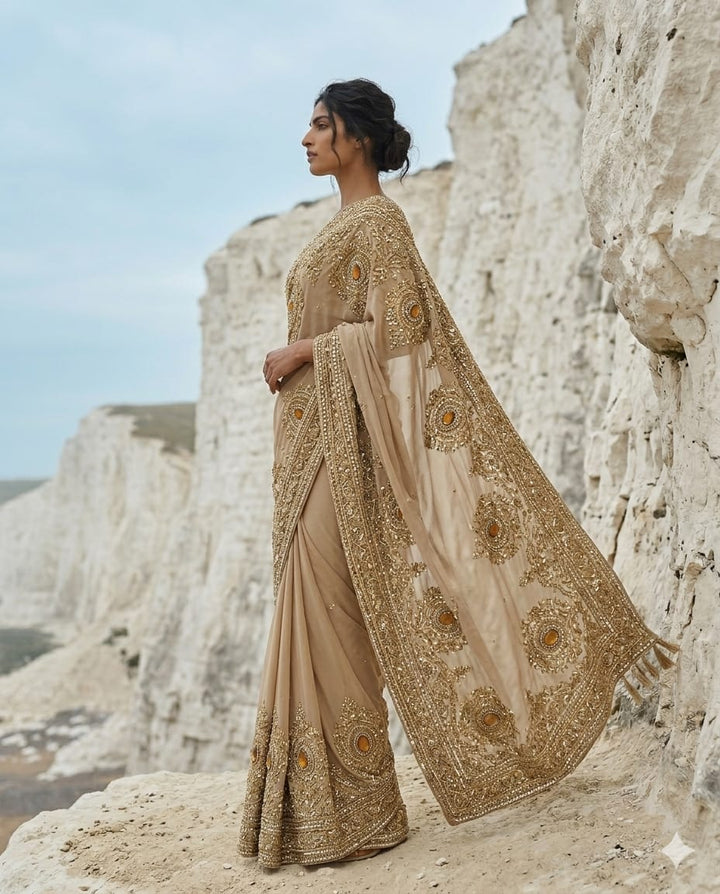 Drop 43 -Ivory gold georgette saree adorned with intricate bead and sequin work.