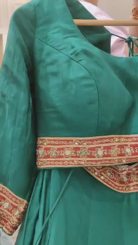 Green crepe crop-top lehenga with heavy embroidery.