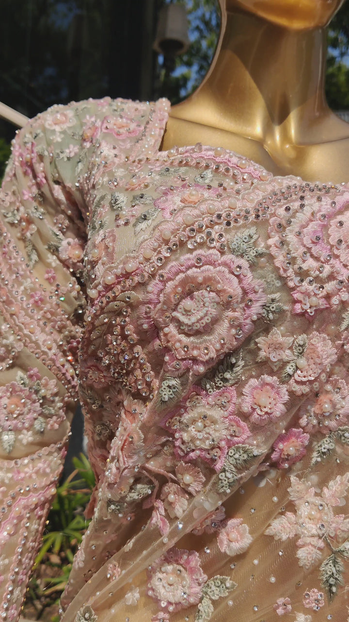 Pista green net saree with elegant bead embroidery and a stitched blouse.