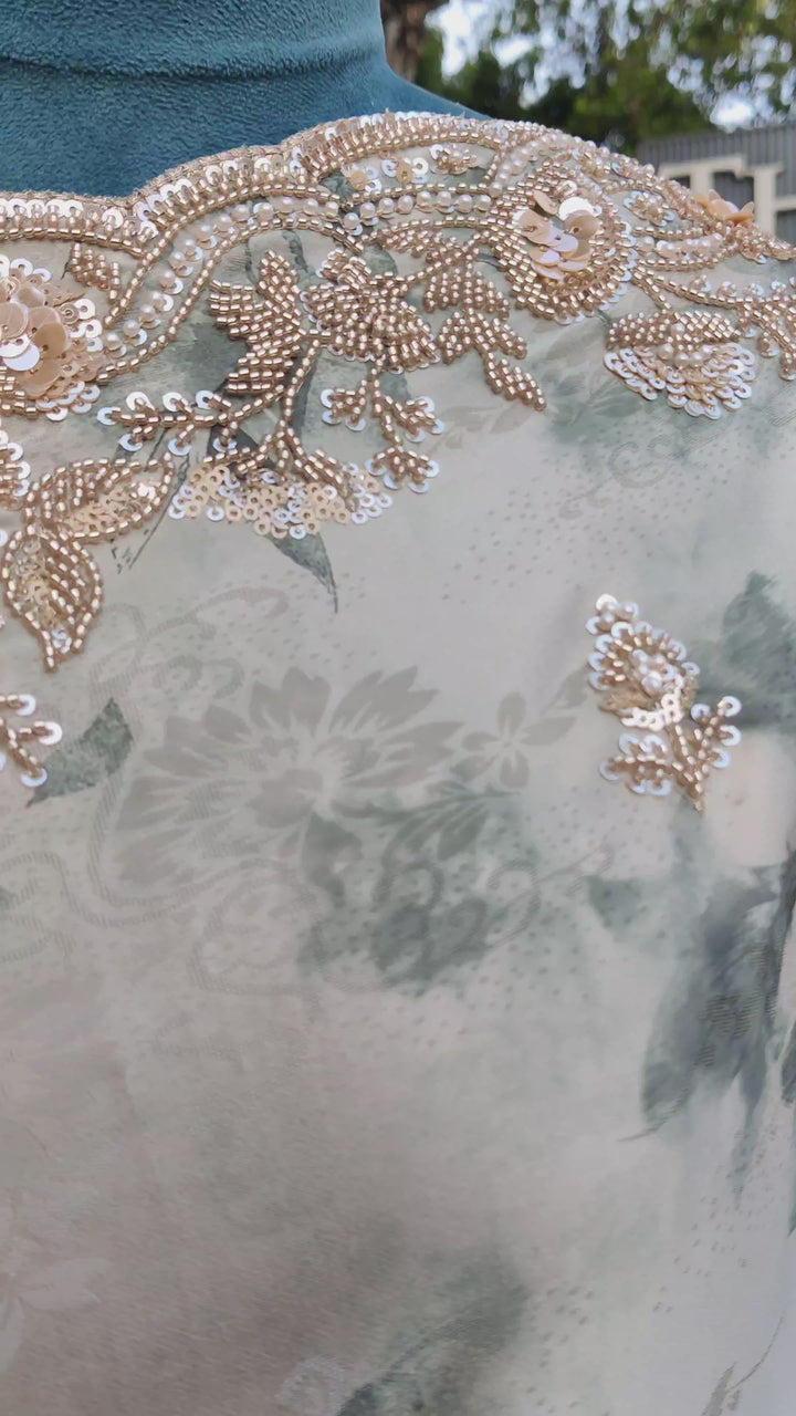 Elegant green saree adorned with intricate bead and sequin embroidery.